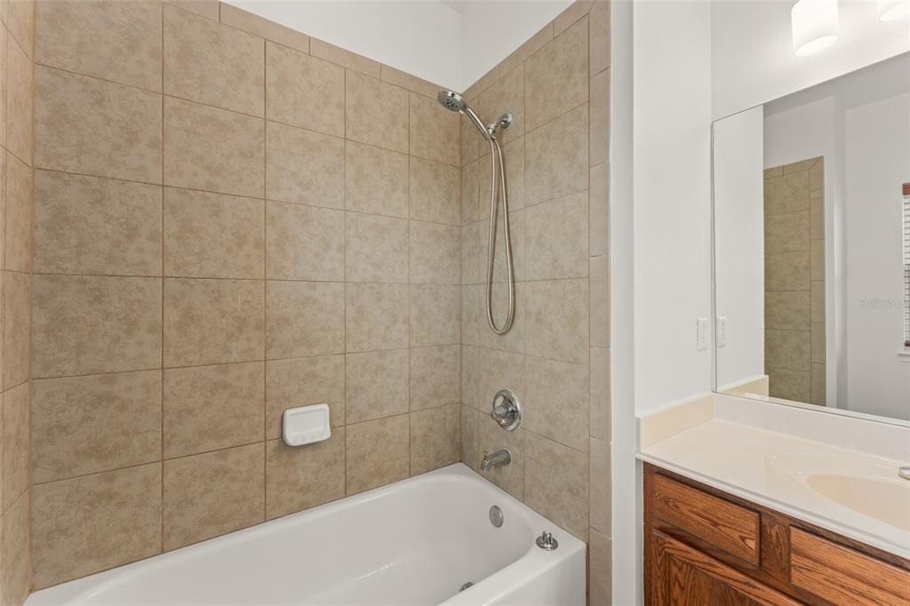 13544 Riggs Way Windermere, FL 34786 - Photo 44 of 58 a bathroom with a bathtub and a shower