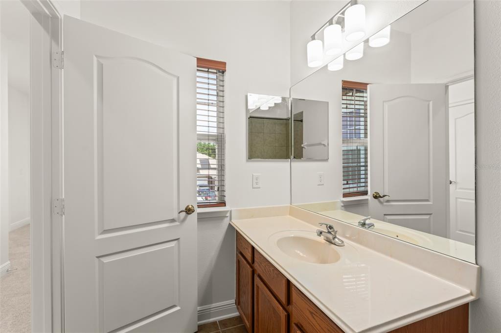 13544 Riggs Way Windermere, FL 34786 - Photo 47 of 58 a bathroom with a sink a mirror and a shower