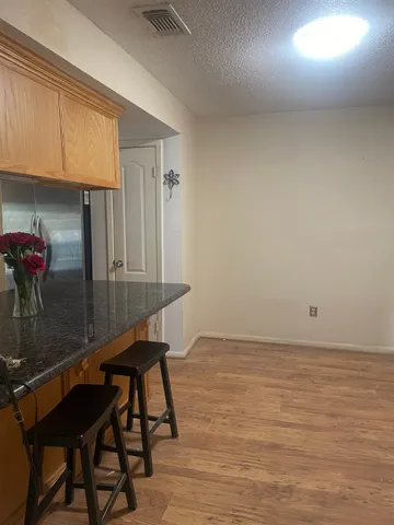 a room with a table chairs and entryway