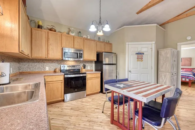 a kitchen with kitchen island a sink stove and refrigerator