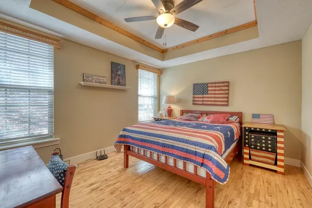 a bedroom with a bed and a chandelier