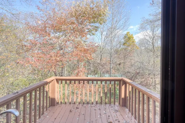 a view of a balcony with wooden fence and floor