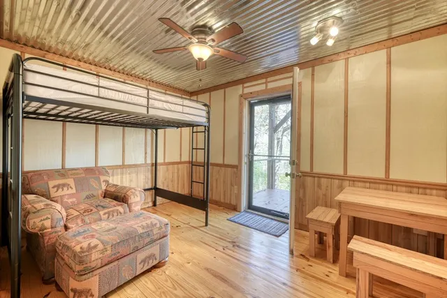 a spacious bedroom with a large bed and a chandelier