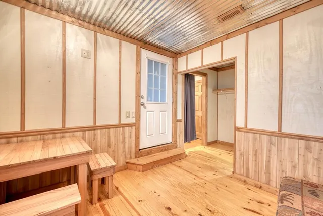 a view of a porch with wooden floor and furniture