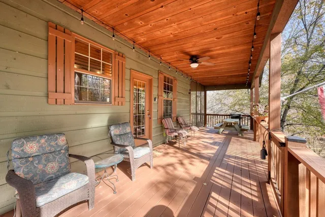 a view of a patio with a table and chairs and couches