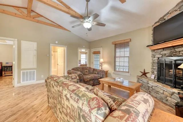 a spacious bedroom with a bed and a flat screen tv