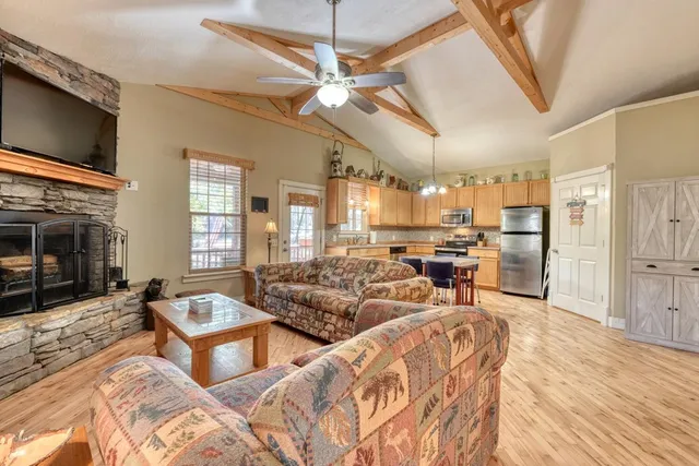 a living room with furniture flat screen tv and a fireplace