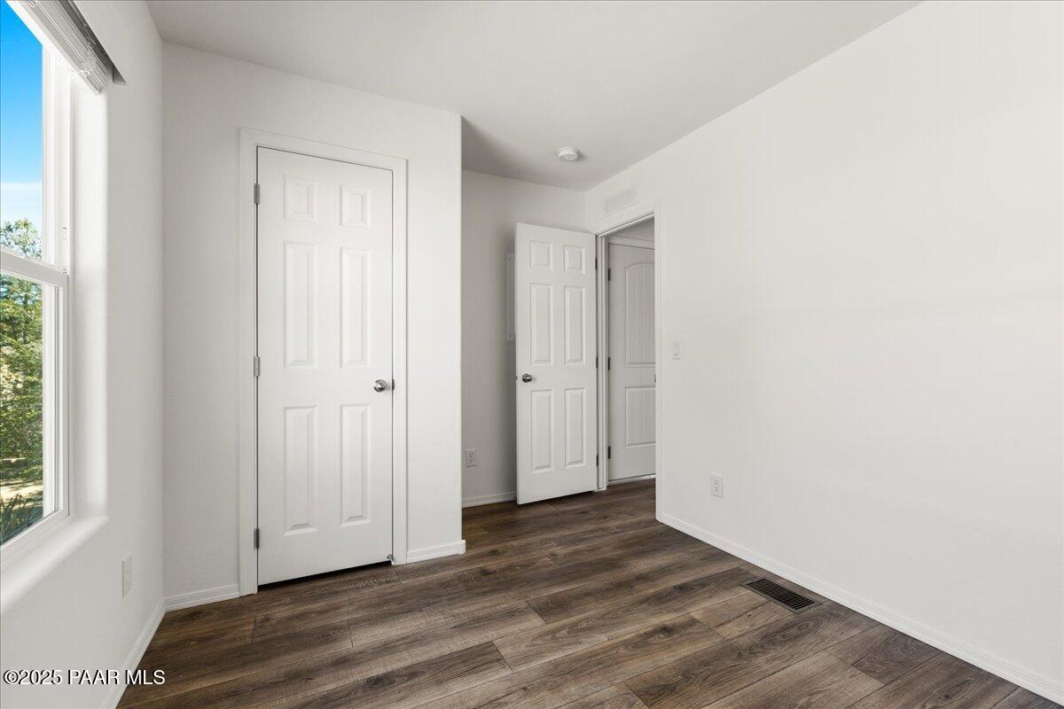 1529 Private Road Prescott, AZ 86301 - Photo 13 of 25 a view of an empty room with wooden floor and a window
