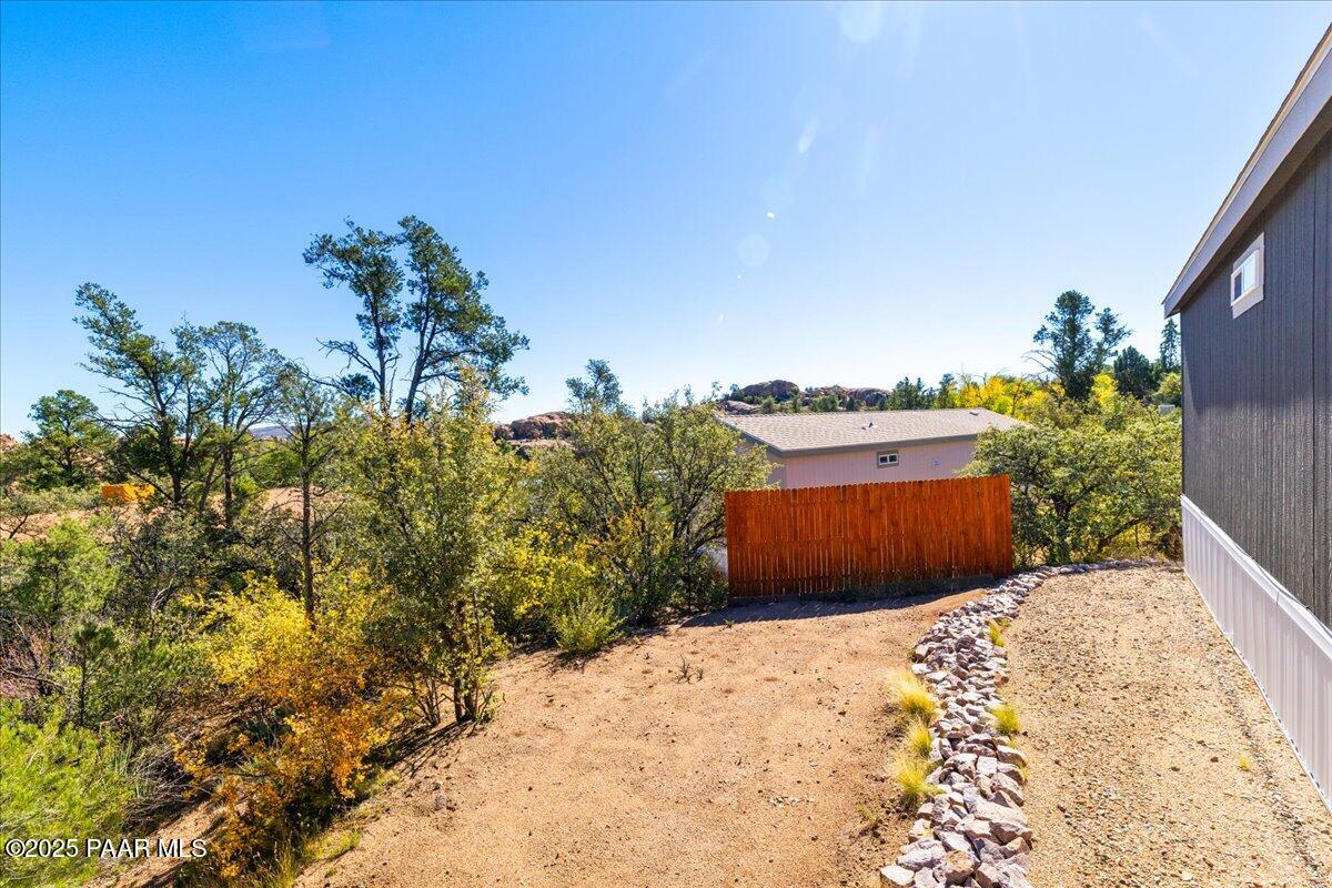 1529 Private Road Prescott, AZ 86301 - Photo 19 of 25 a view of a dry yard with plants and a bench