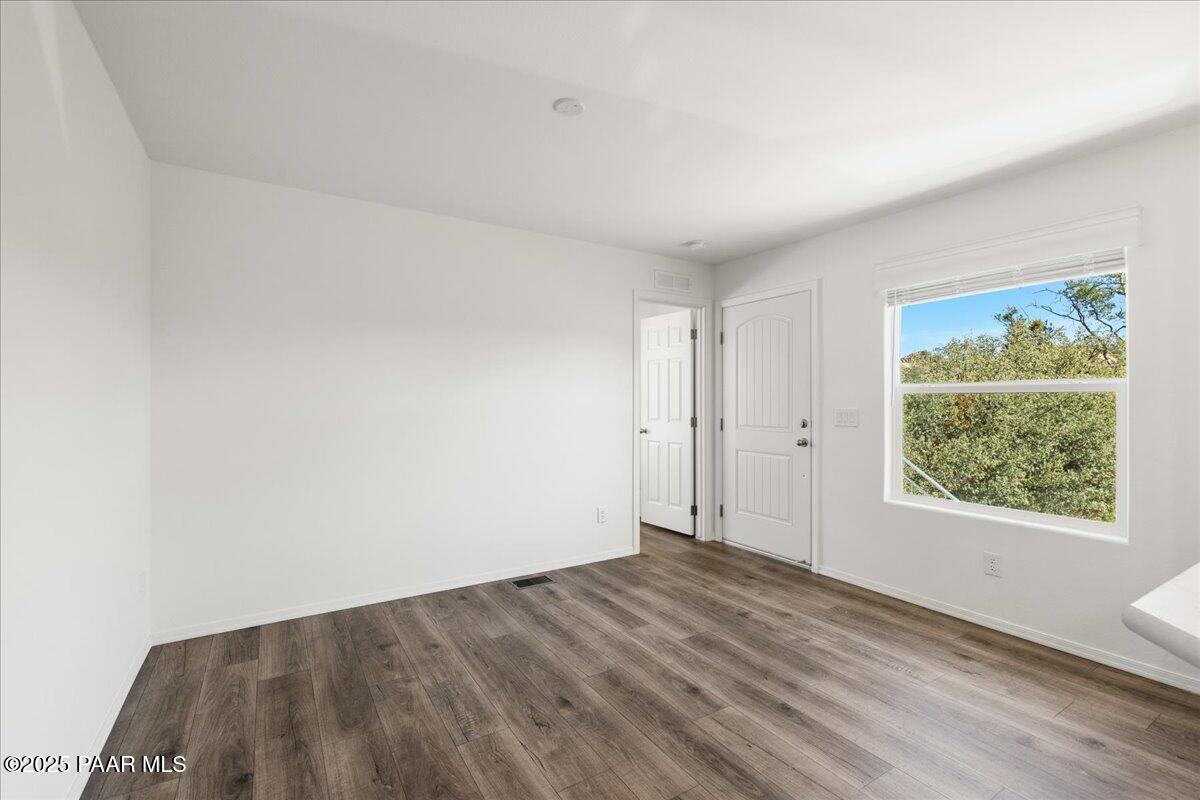 1529 Private Road Prescott, AZ 86301 - Photo 3 of 25 a view of an empty room with wooden floor and a window
