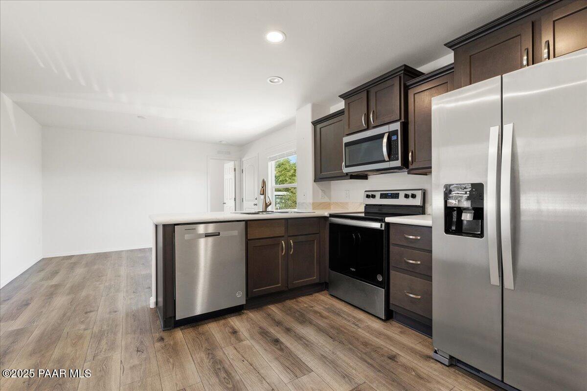 1529 Private Road Prescott, AZ 86301 - Photo 9 of 25 a kitchen with granite countertop a refrigerator and a sink