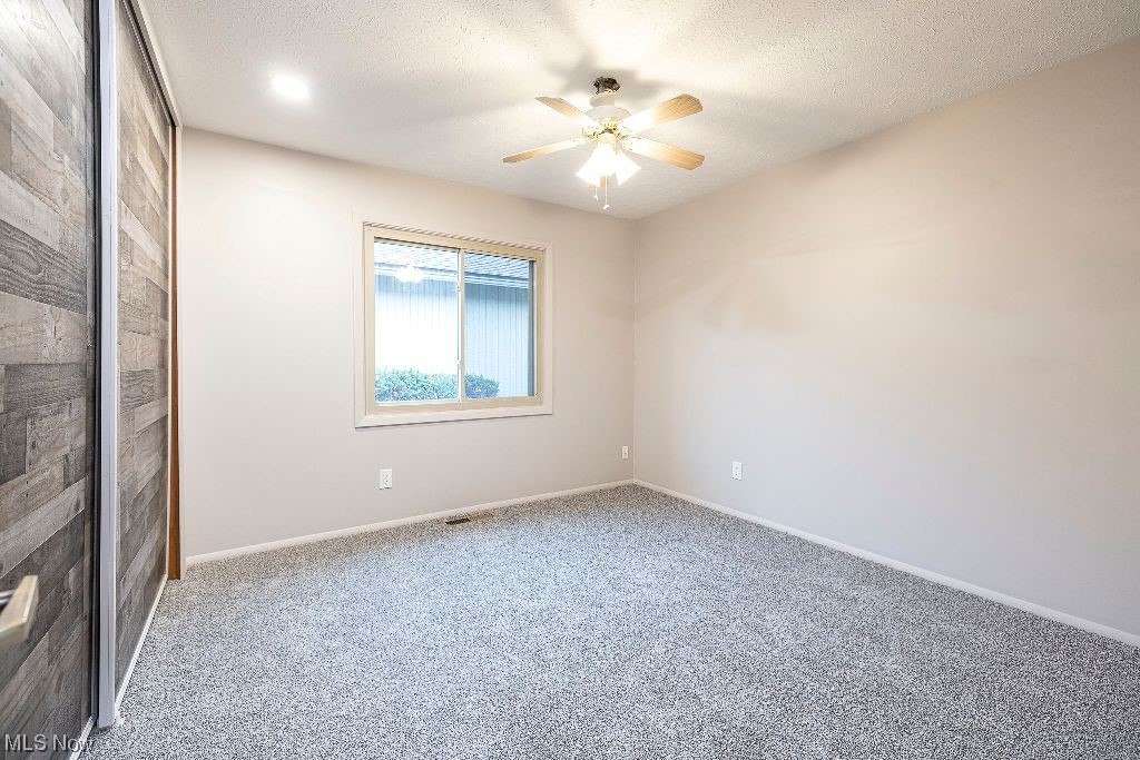 10808 Priem Road Strongsville, OH 44149 - Photo 20 of 26 Unfurnished room featuring ceiling fan, light carpet, and a textured ceiling