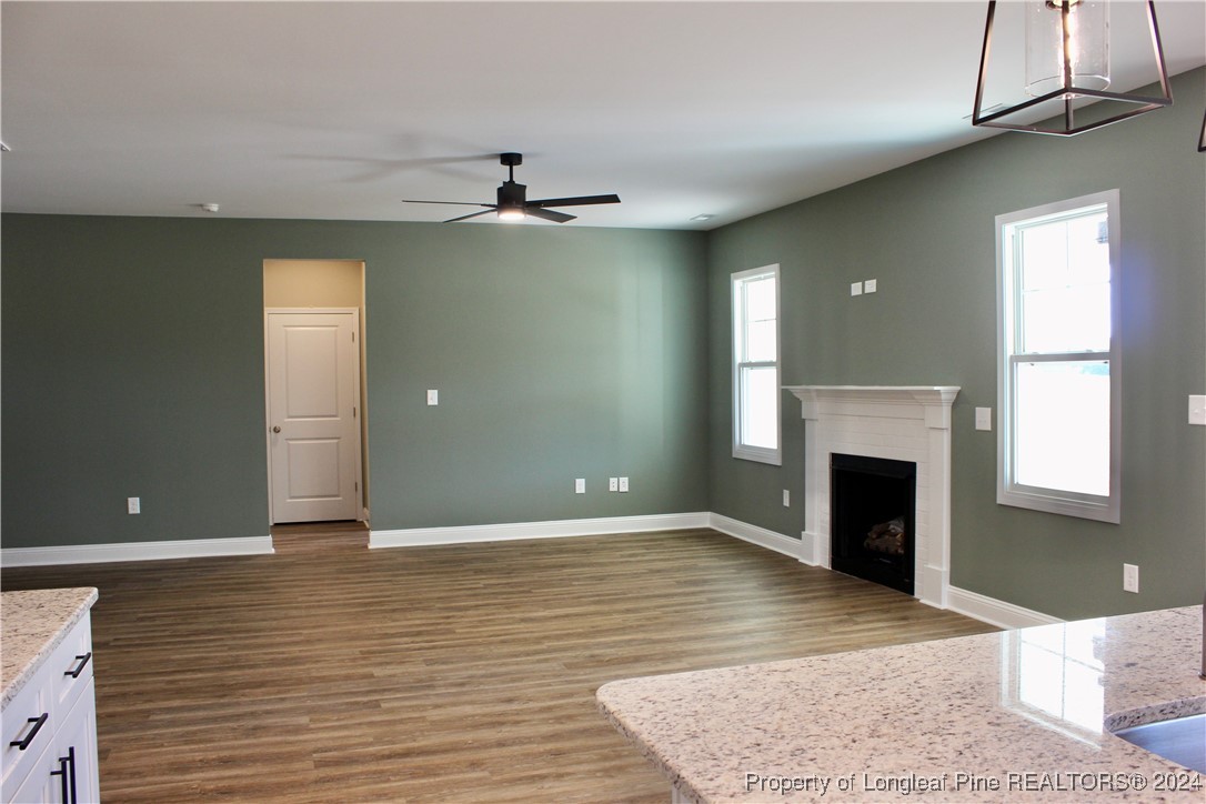 6119 Stewart Road Godwin, NC 28344 - Photo 10 of 20 an empty room with windows and a fireplace