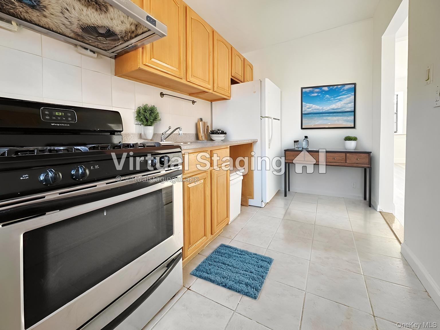 78-16 147th Street, Unit 3C Queens, NY 11367 - Photo 4 of 16 Kitchen with stainless steel range with gas stovetop, exhaust hood, light tile patterned flooring, light countertops, and tasteful backsplash