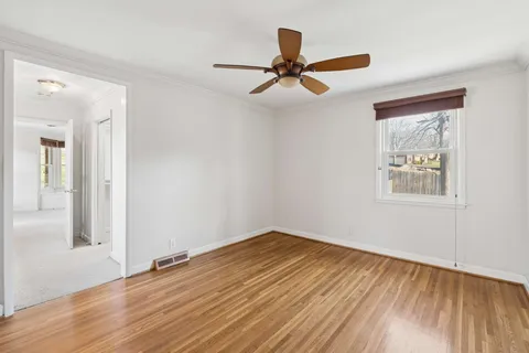 wooden floor in an empty room with a window