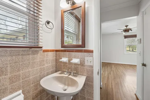 a bathroom with a sink a mirror and a window
