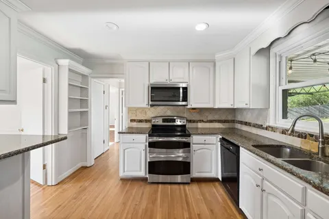 a kitchen with a stove a sink and a microwave