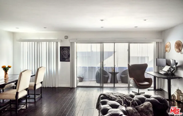 a living room with furniture and large windows