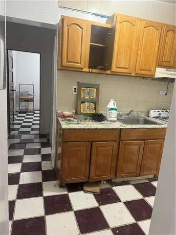 a kitchen with stainless steel appliances granite countertop a sink and a cabinets