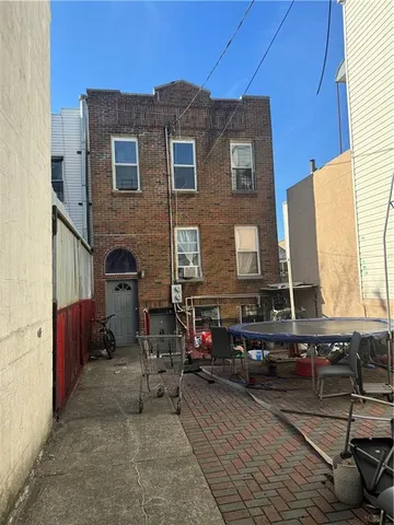 a front view of a house with outdoor seating