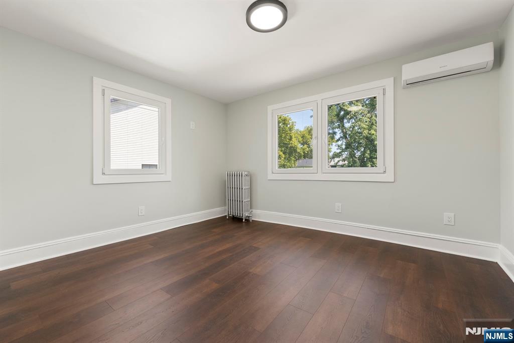 240 Berry Street Hackensack, NJ 07601 - Photo 12 of 25 a view of an empty room with wooden floor and a window