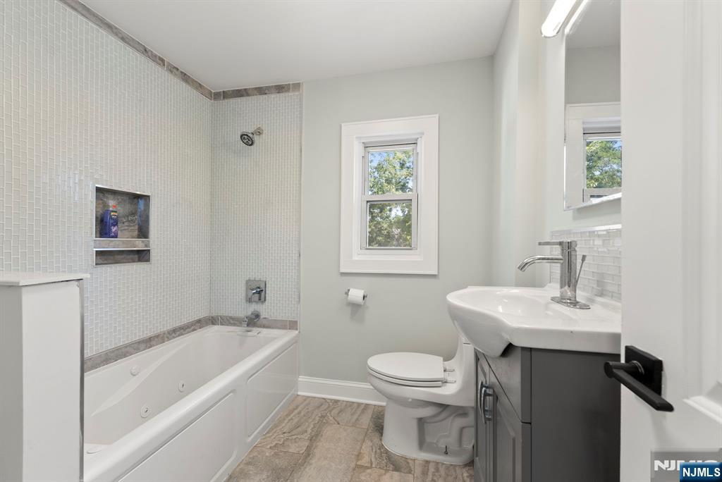 240 Berry Street Hackensack, NJ 07601 - Photo 15 of 25 a bathroom with a sink toilet vanity and bathtub