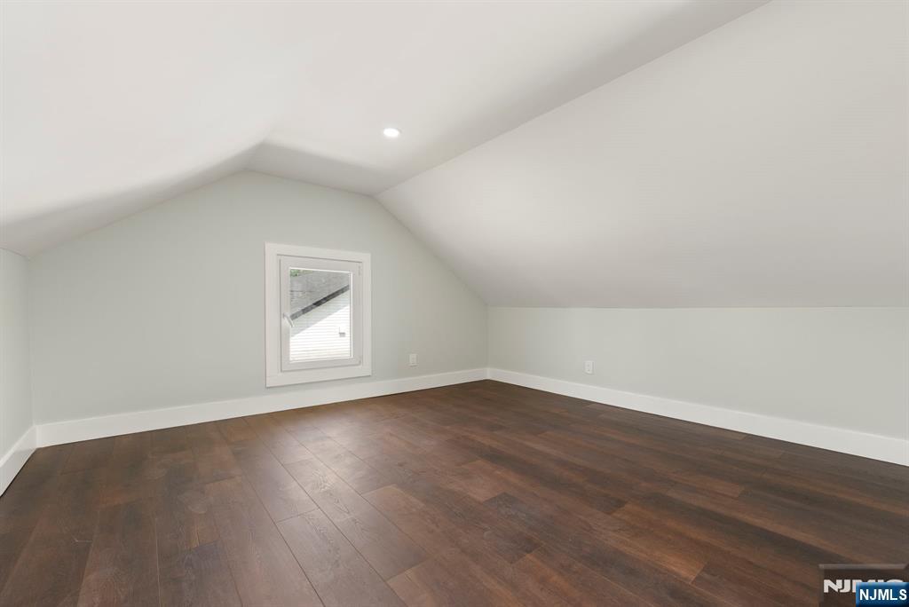 240 Berry Street Hackensack, NJ 07601 - Photo 16 of 25 an empty room with wooden floor and windows