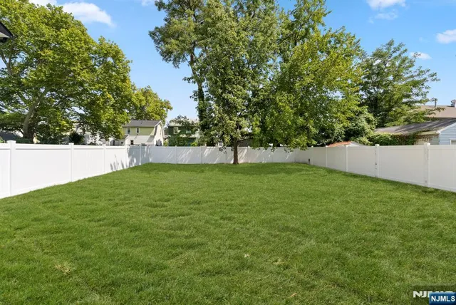 a view of green field with trees in the background