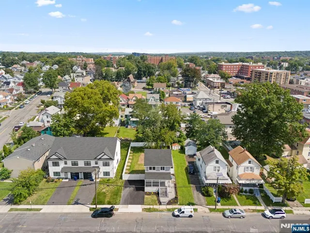 an aerial view of residential houses with city view