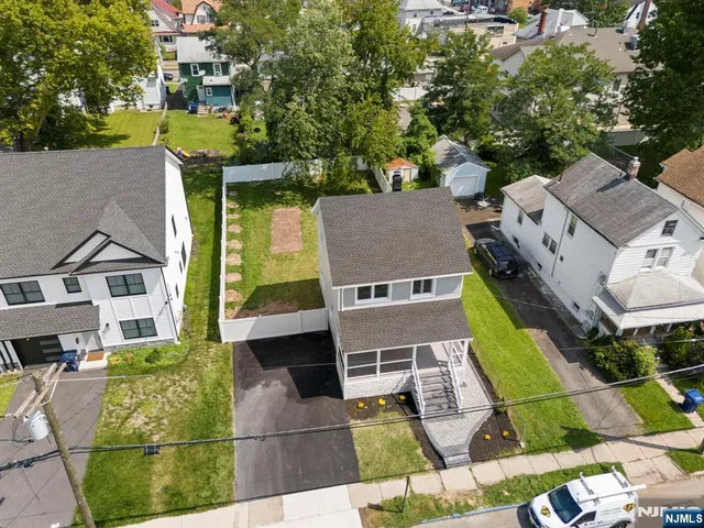 an aerial view of a house with a yard and lake view
