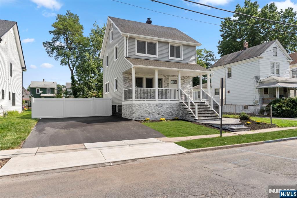 240 Berry Street Hackensack, NJ 07601 - Photo 3 of 25 a front view of a house with a yard and garage