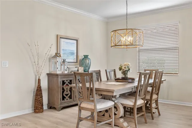 a view of a dining room with furniture wooden floor and chandelier