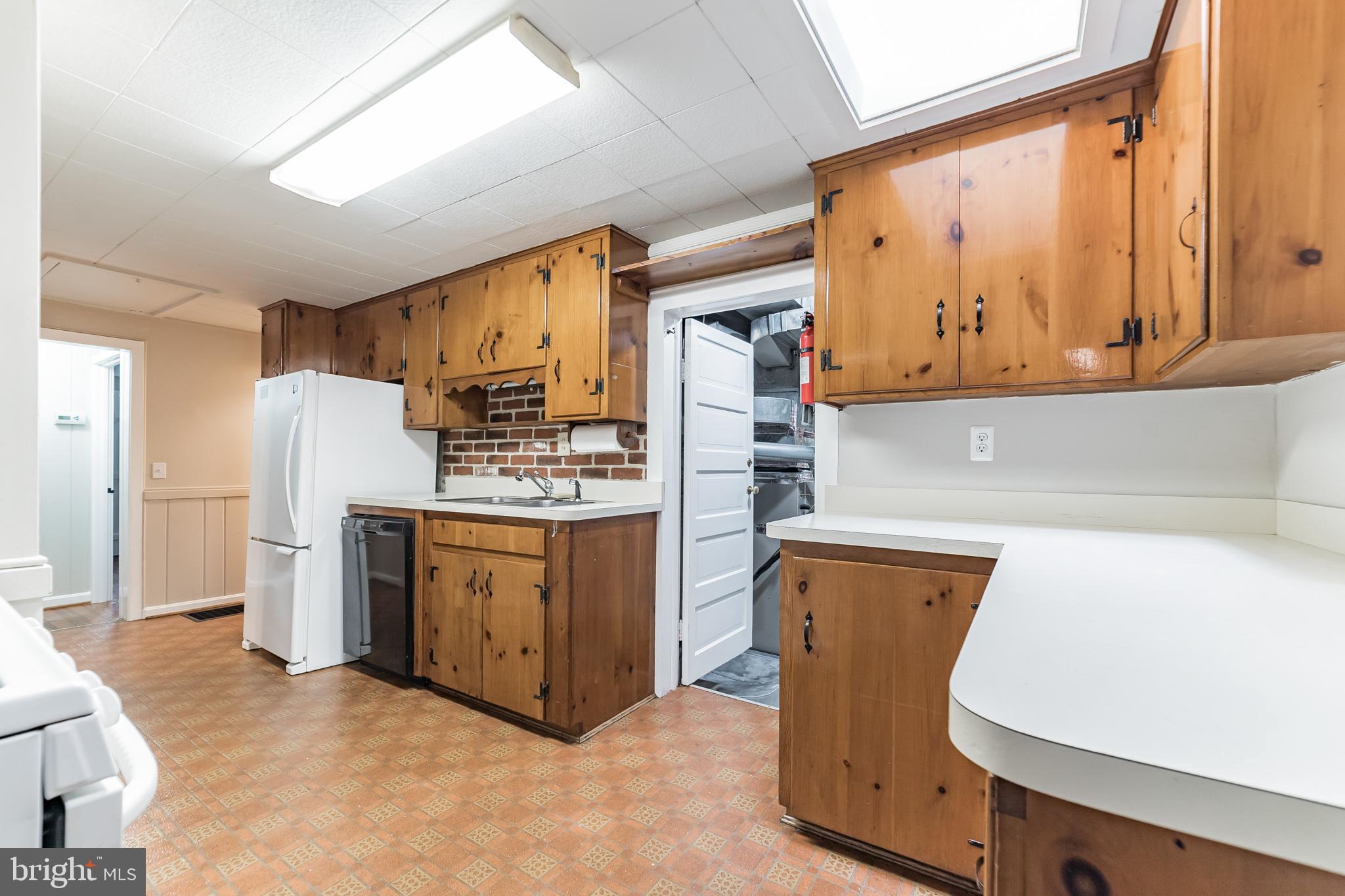 818 Tanley Road Silver Spring, MD 20904 - Photo 6 of 31 Kitchen with skylight showing laundry room