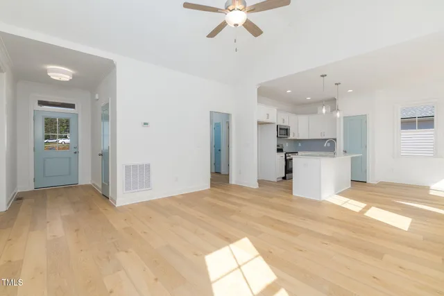 a view of a kitchen with a sink and a refrigerator
