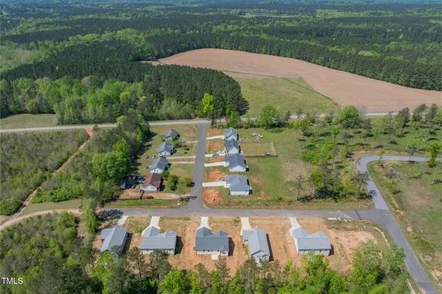 an aerial view of a residential houses with outdoor space and street view