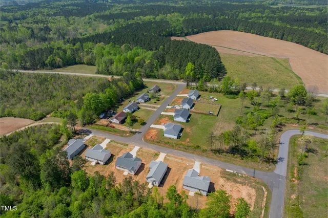 an aerial view of a house with outdoor space