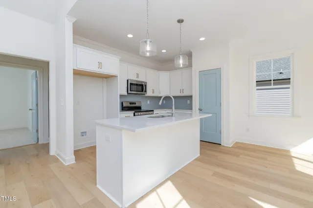 a view of kitchen with sink and refrigerator