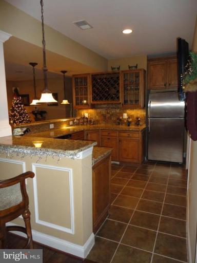 7878 Pembridge Road Manassas, VA 20112 - Photo 2 of 8 Basement bar w/granite, wine rack, refrigerator