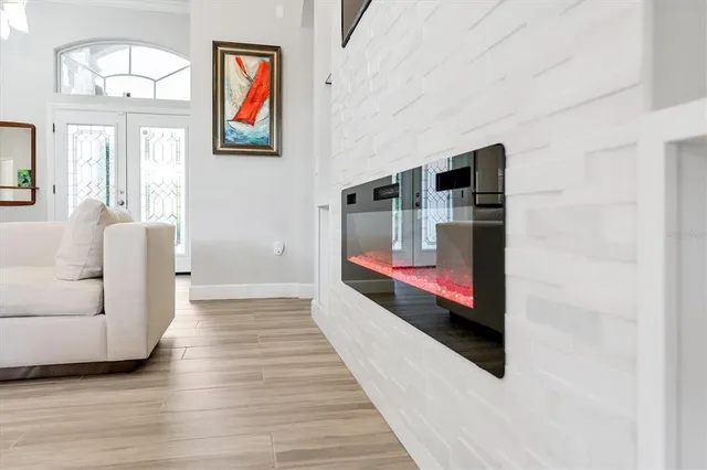 a kitchen with stainless steel appliances white cabinets and wooden floor