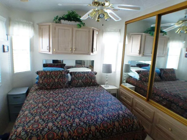 a bedroom with a large bed and a chandelier