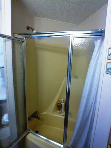 a bathroom with a shower and a tub