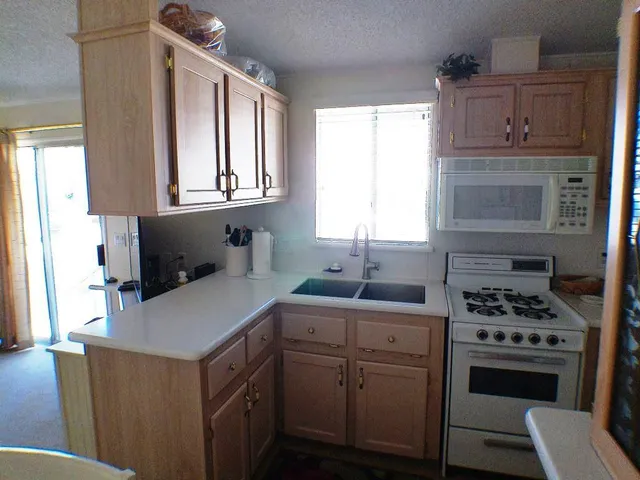 a kitchen with a stove and a refrigerator