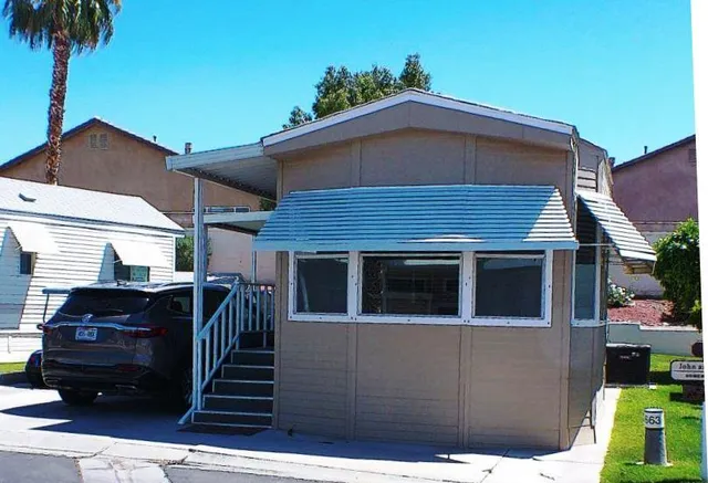 a front view of a house with parking space