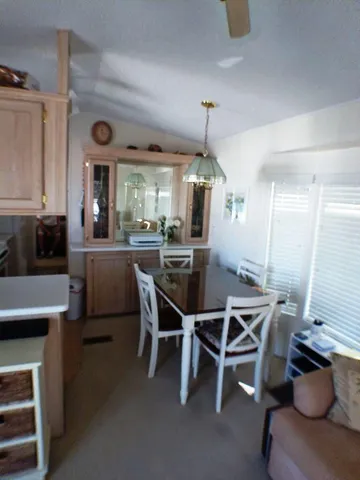 a living room with furniture a dining table and chairs