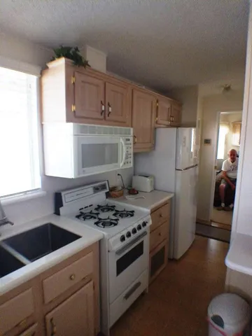 a kitchen with a stove sink and cabinets