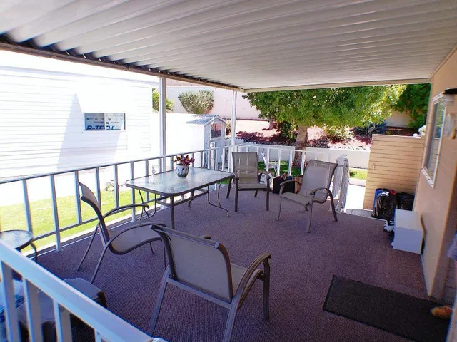 a view of a patio with a table and chairs