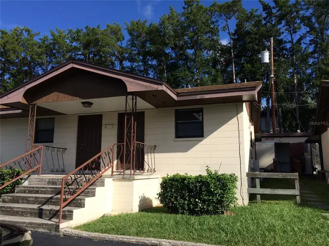 a view of house with yard outdoor seating and green space