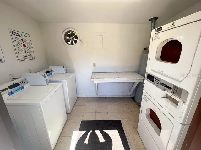 a living room with a bed furniture and a window