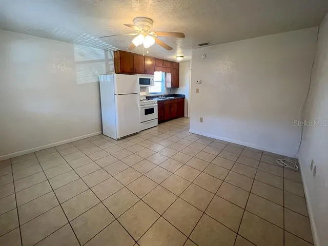a view of a kitchen with cabinets and stainless steel appliances