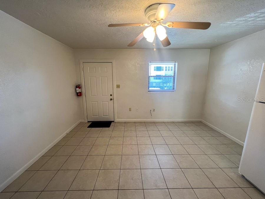 1406 Southwest 18th Place, Unit 4 Gainesville, FL 32608 - Photo 5 of 16 an empty room with a ceiling fan and a window